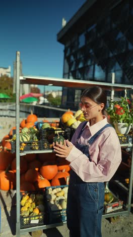 woman shopping for pumpkins at a fall market