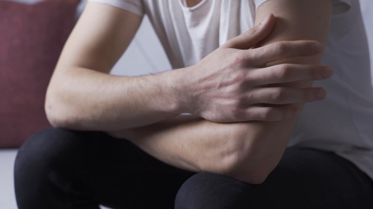 Close-up of mentally ill man's hands.
