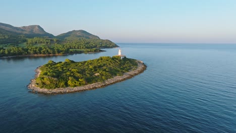 Beautiful-cinematic-Alcanada-lighthouse-on-open-calm-ocean,-aerial-orbit