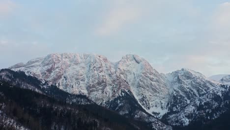 White-Rocky-Mountains-And-Lush-Forest-Scenery---aerial-shot