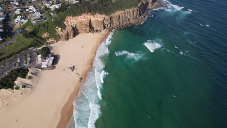 ocean waves splashing at redhead beach in new south wales, australia - aerial shot