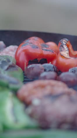 grilling peppers and meat on a barbecue