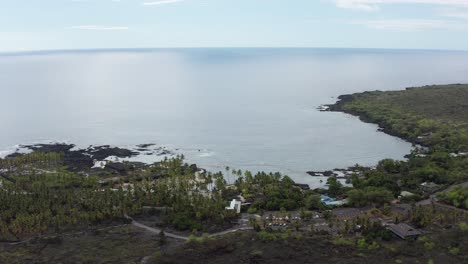 Aerial-low-panning-shot-of-Pu'uhonua-O-Honaunau-National-Historical-Park-and-Honaunau-Bay,-also-know-as-Two-Steps-Beach,-on-the-leeward-side-of-the-Big-Island-of-Hawai'i