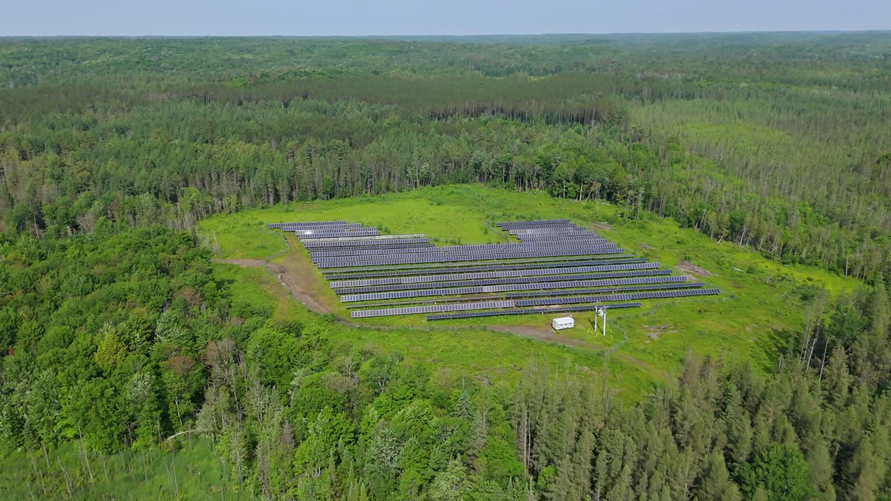 Aerial Flyover Of Solar Panels In A Solar Farm Surrounded By Forest In Muskoka, Ontario, Canada.