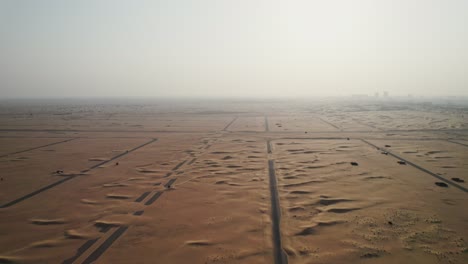 aerial view of empty desert land with roads and development