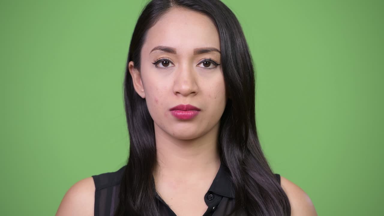 Young beautiful Asian businesswoman with finger on lips