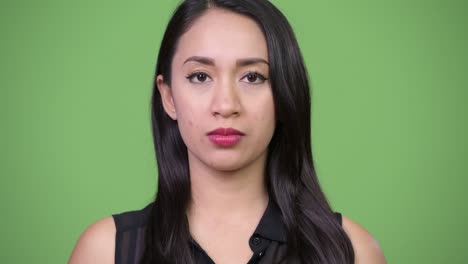 young beautiful asian businesswoman with finger on lips
