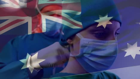 Animation-Der-Flagge-Australiens,-Die-über-Einem-Kaukasischen-Chirurgen-Weht,-Der-Einer-Chirurgin-Hilft,-Eine-Maske-Zu-Tragen