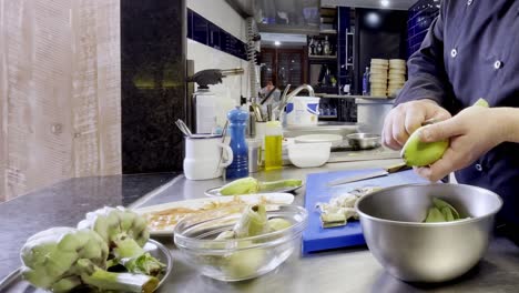 Pealing-artichokes-while-preparing-special-Spanish-dish