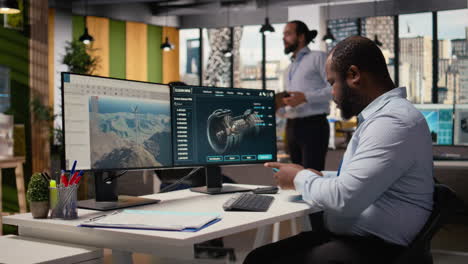 technician working on wind turbine simulation in office, doing upgrades