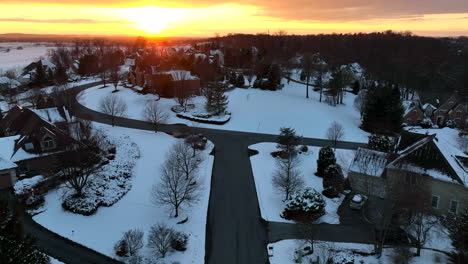 american neighborhood community in winter snow at sunset