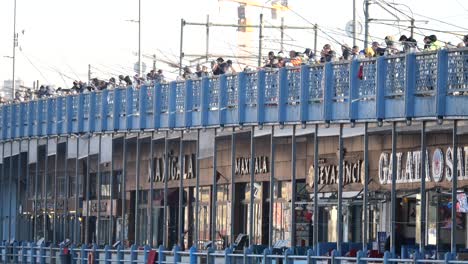 people fishing from the galata bridge in istanbul