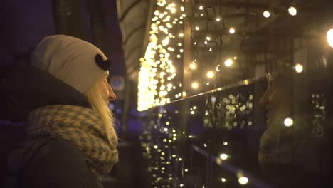 a woman looks at the city garland in anticipation of the holiday.