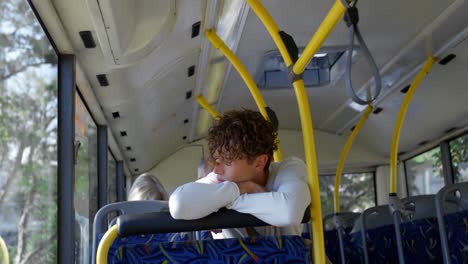 male commuter looking through window while travelling in bus 4k