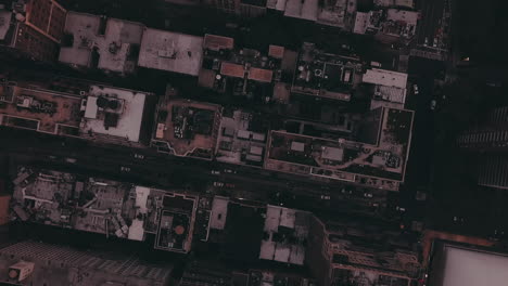 AERIAL:-Overhead-View-of-Skyscraper-Building-Rooftops-in-Manhattan-New-York-City-at-Dawn-after-Sunset