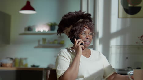 african american woman speaking on phone at home