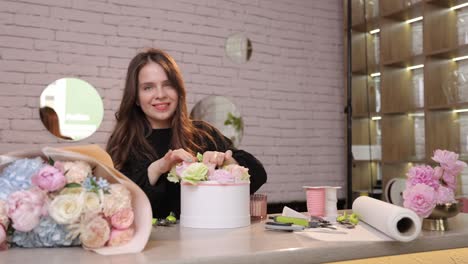 A Skilled Florist Artfully Arranges an Exquisite Selection of Delicate Flowers Inside a Chic White a Skilled Florist Artfully Arranges an Exquisite Selection of Delicate Flowers Inside a Chic White Container