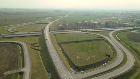 Aerial-trucking-shot-showing-modern-infrastructure-with-new-built-highway-and-junction-during-sunny-day-in-Poland