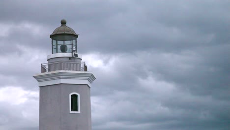 an old lighthouse in a grey cloudy thunderstorm, on a coast in puerto rico