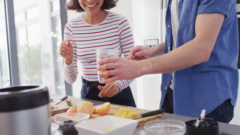 video of midsection of diverse couple preparing juice