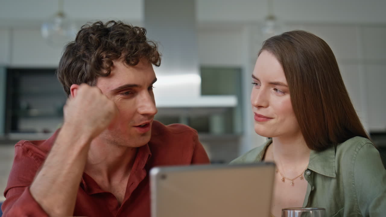 Family couple discussing tablet content sitting home kitchen together closeup