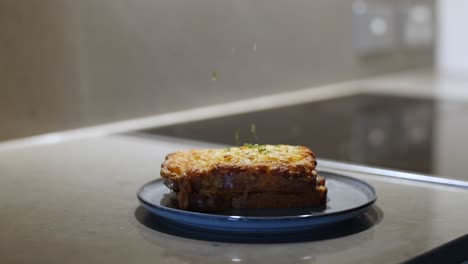 Slow-motion-sprinkling-of-chives-on-breakfast-sandwich