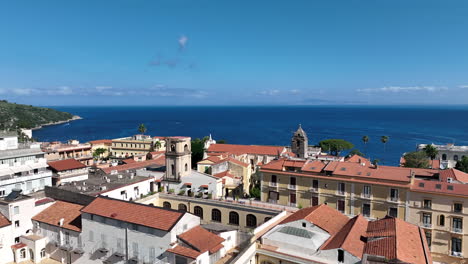 Slow-aerial-flyover-of-buildings-at-the-coastal-edge-of-Sorrento-with-the-Mediterranean-Sea-in-the-background-in-Italy