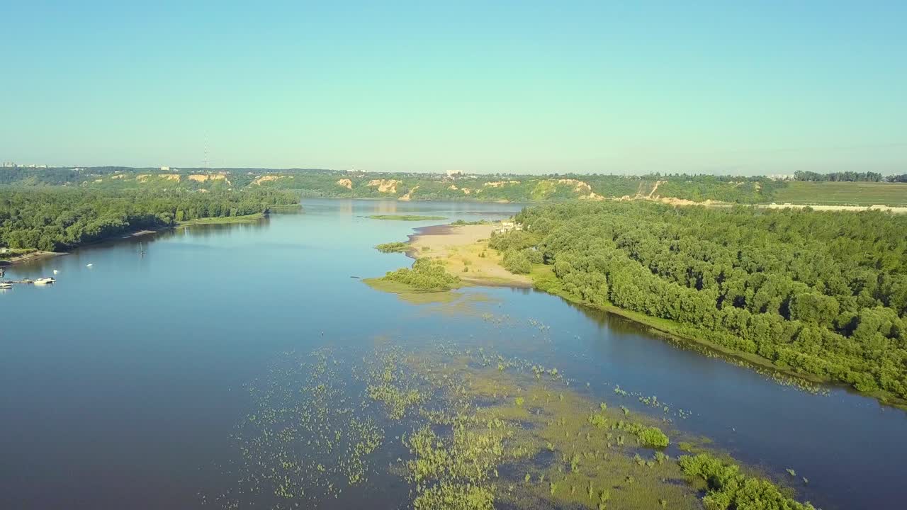 Riprese aeree: volo sopra la palude dal molo verso il paesaggio urbano.