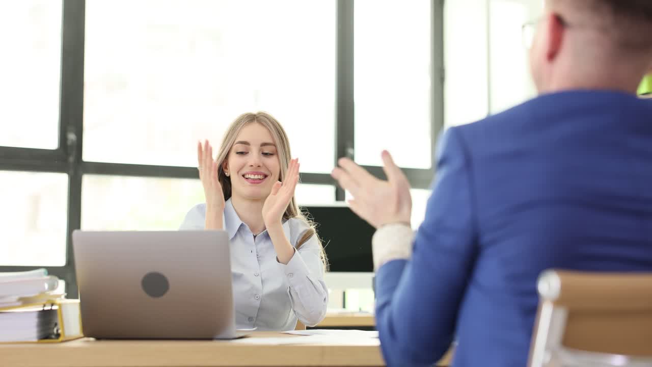 Business people in an office celebrating success