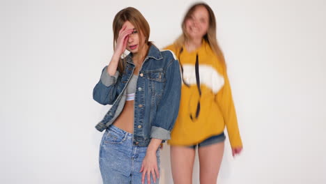 two young women posing in casual outfits