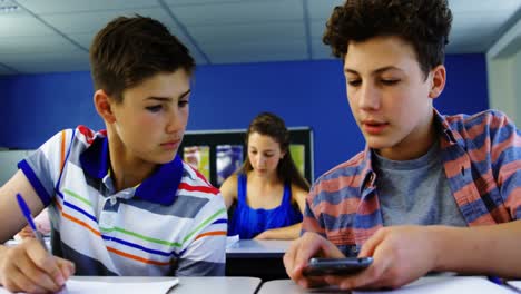 student using mobile phone in classroom