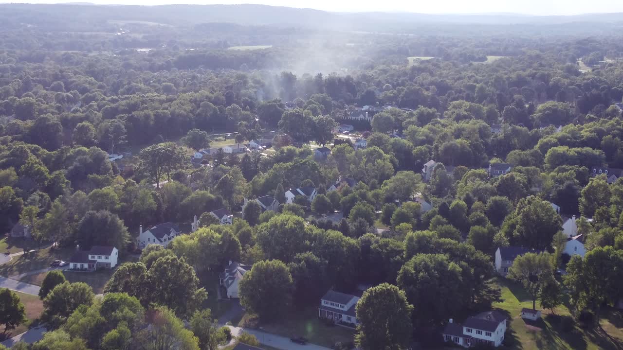smoke from a house fire flows over houses