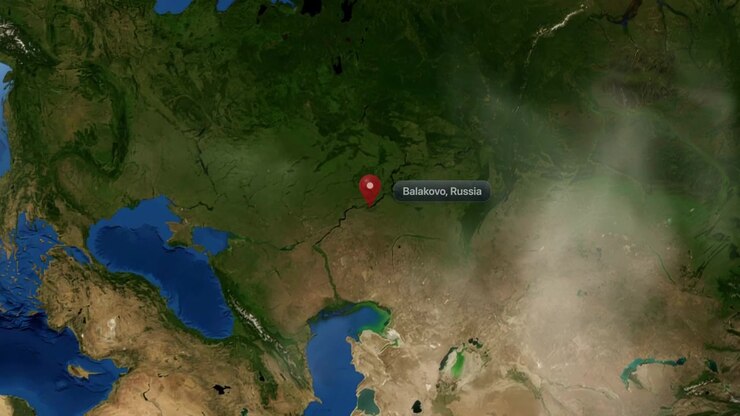 Satellite view camera zooms in from space to pinpoint Balakovo, Russia on realistic 3D globe. Includes NASA public domain imagery.