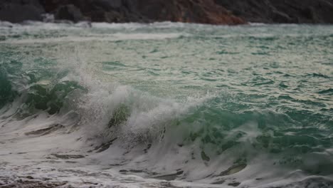 powerful waves are crashing and spilling on the sandy beach