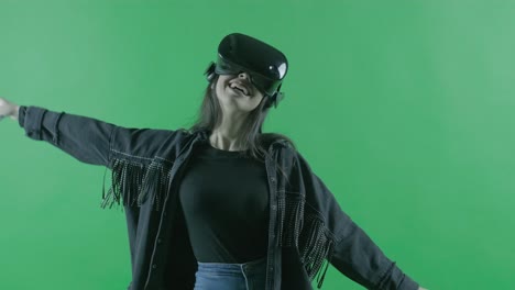 happy young beautiful woman dancing in the vr headset. virtual reality helmet on the green background. chroma key