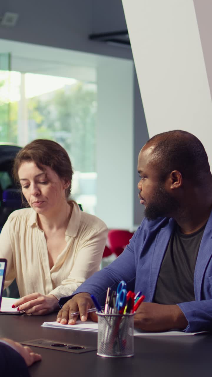 Diverse Colleagues Discussing Documents in a Professional Office Meeting