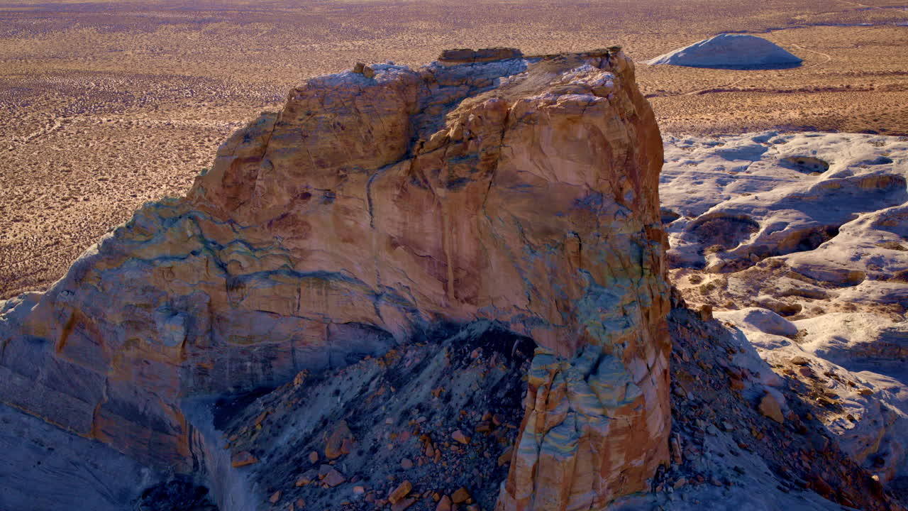 A sweeping drone shot circles the breathtaking eroded rock formations of Glen Canyon and Lake Powell near Page, Arizona.