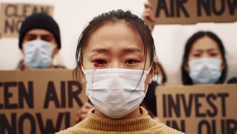 emotional protest faces: demonstrators standing for clean air amidst environmental crisis and social unrest, highlighting the urgency of action for a sustainable future