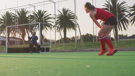 Female-hockey-players-playing-on-the-field