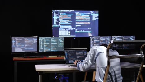 programador que trabaja en varios monitores de computadora