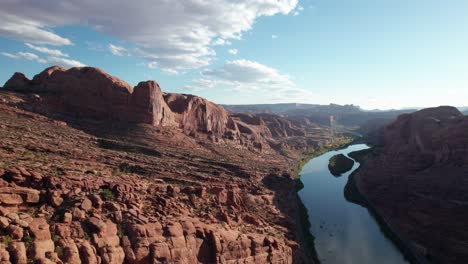 dramatic drone shot of the colorado river in a canyon outside of moab, utah