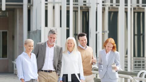 diverse group of business colleagues walking and talking outdoors