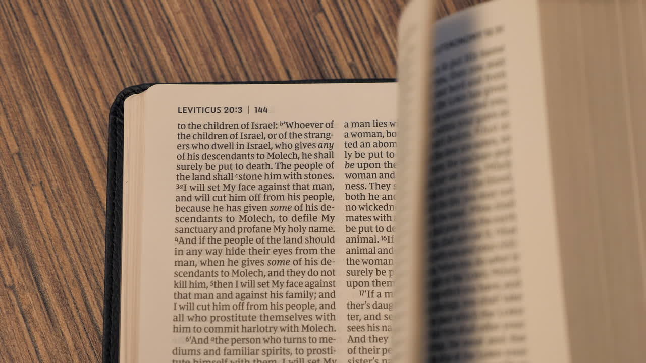 Turning Pages in Holy Bible from the book of Genesis to Revelation