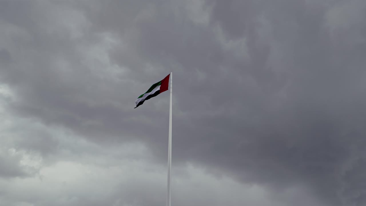 A view of the UAE national flag under overcast conditions in Sharjah