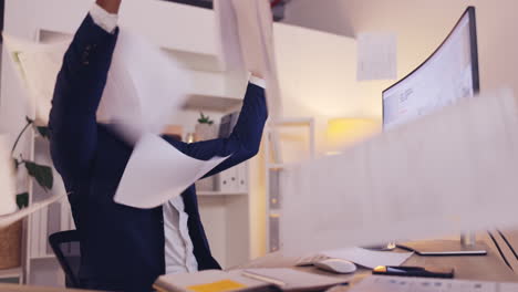 happy man throw papers in office success