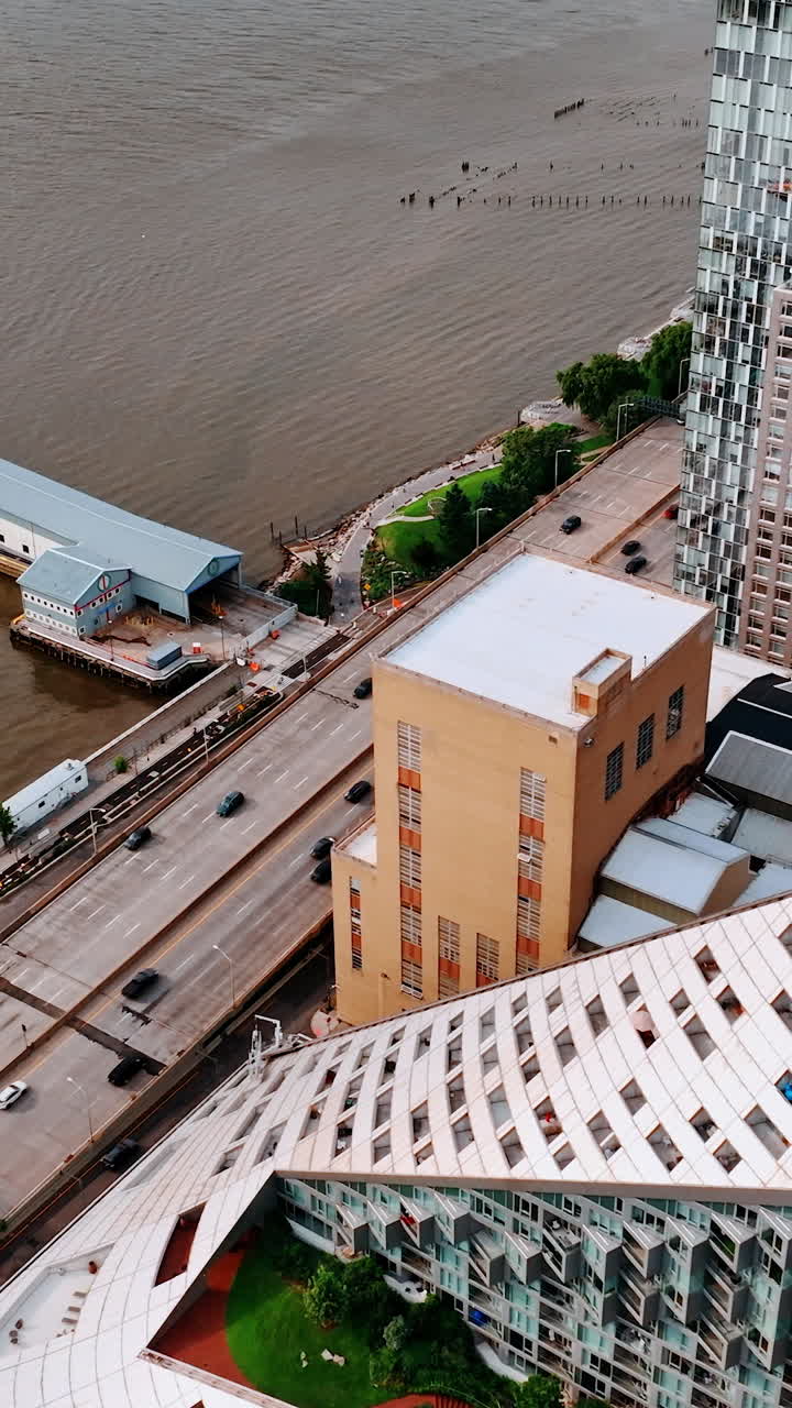 Sight of the unusual white triangle building from top. Drone footage moving to the piers of New York. Vertical video