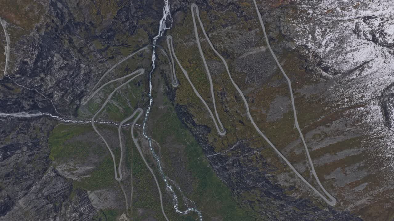 Serpentine mountain pass in Norway with cars seen from above
