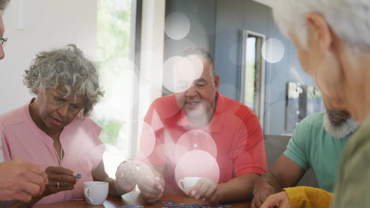 Playing puzzle game, elderly friends with animation of bubbles in scene