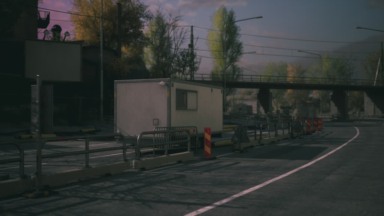 Quiet road under a bridge with construction barriers and trailers in rural area