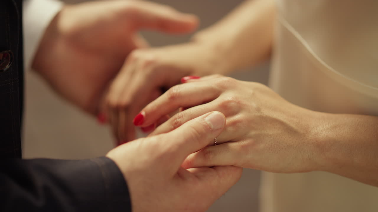 Young man and woman holding hands. Unknown newlywed couple just married